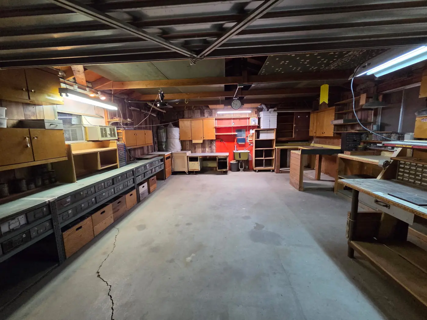 Garage after: floor cleared, workbenches and shelving empty