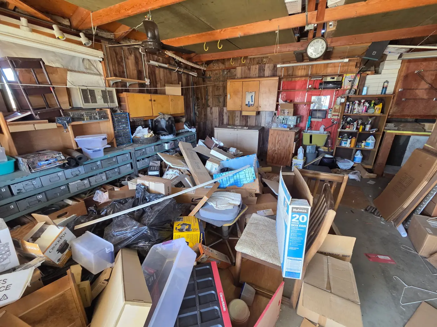 Garage before: piled with boxes, bags, chairs and clutter
